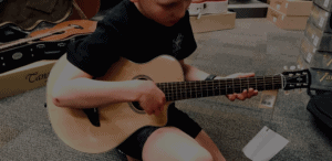 Child with 3/4 size guitar