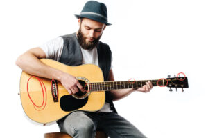 Man Inspecting a Secondhand Acoustic Guitar